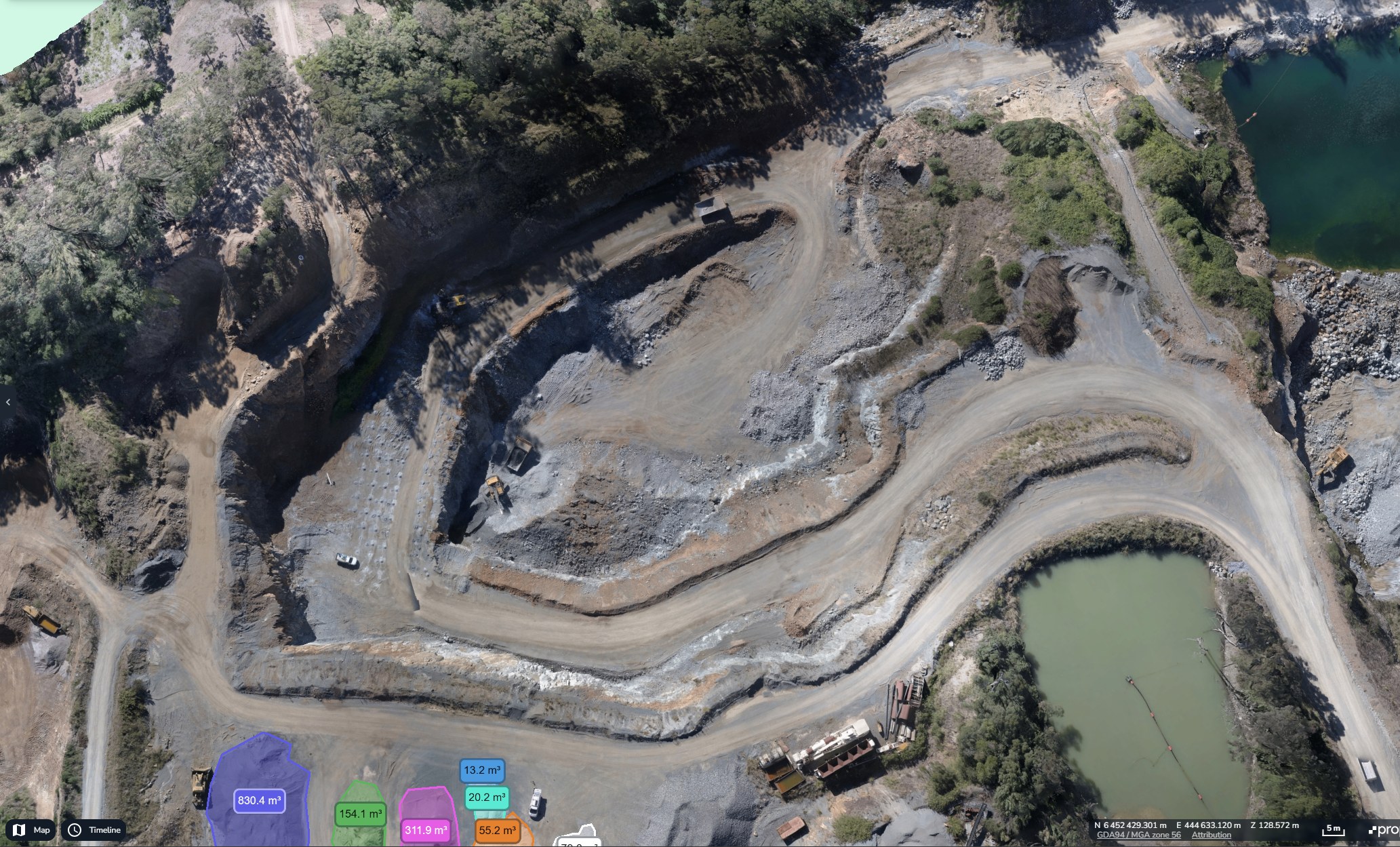 Orthomosaic of a quarry from a drone survey, showing benches, haul roads, ponds and measured stockpiles